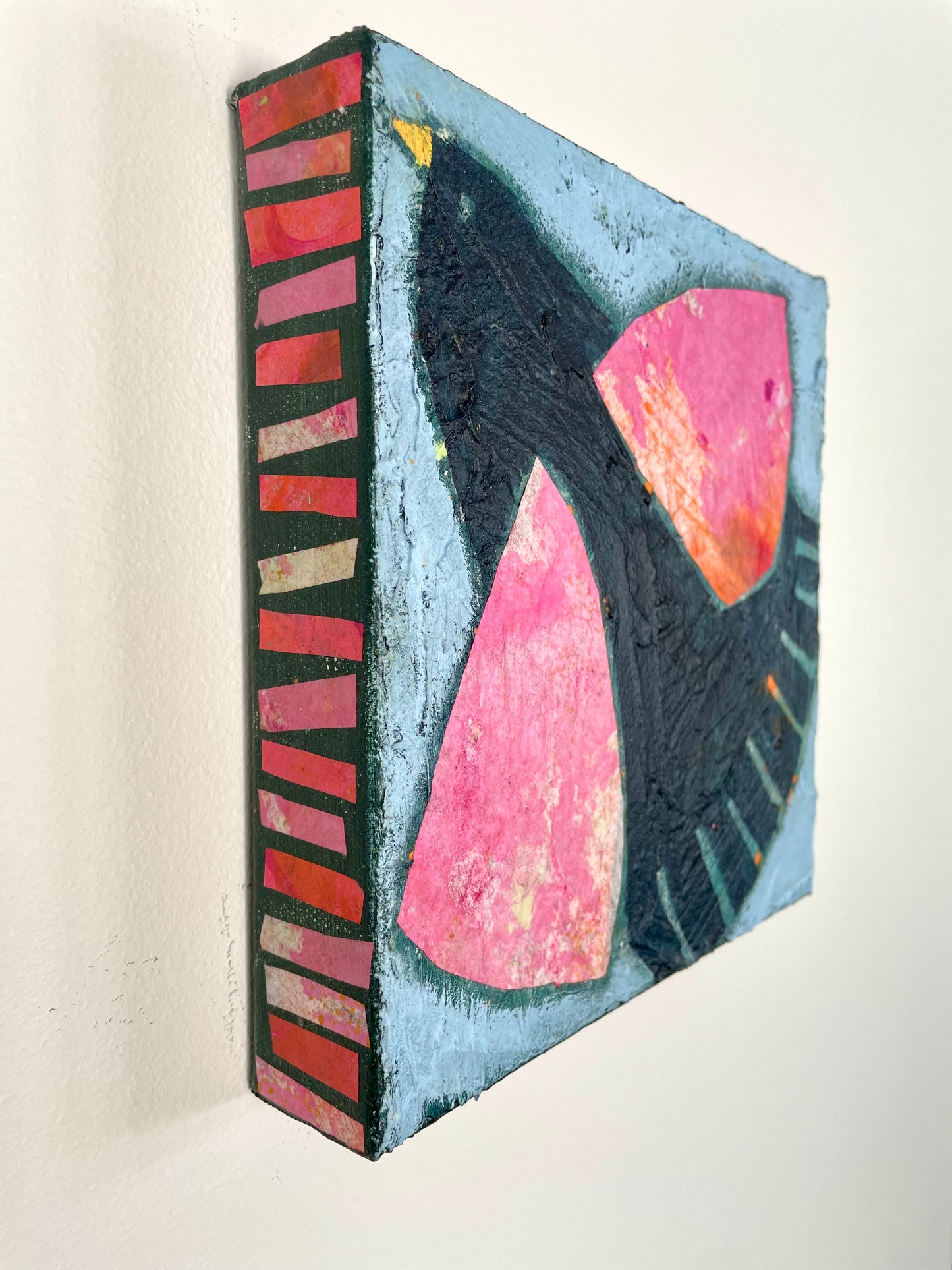 Side view of Black Bird Singing showing collaged canvas edges matching the colourful pink wings