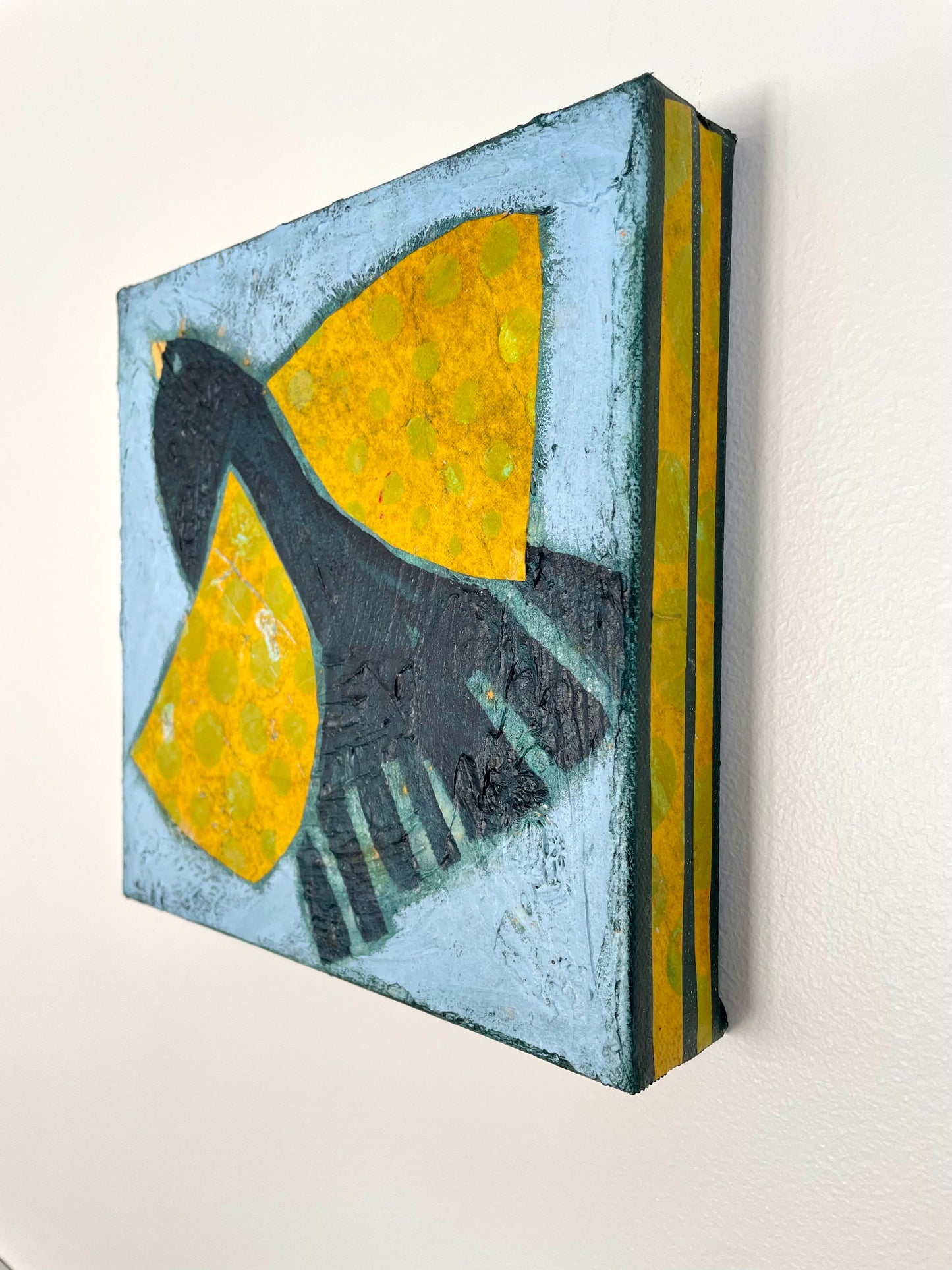 Side view of Waiting for This Moment to Arise showing yellow striped canvas edges and surface details 