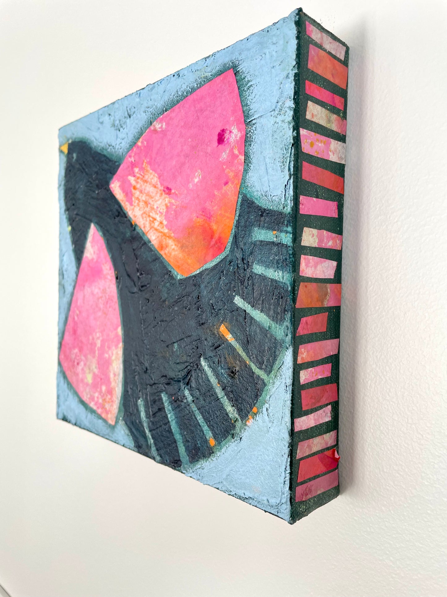 Black Bird Singing abstract blackbird with pink wings painting displayed on a wall in a home setting